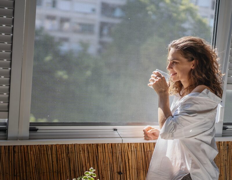 Young,Smiling,Caucasian,Woman,In,A,White,Shirt,Standing,On